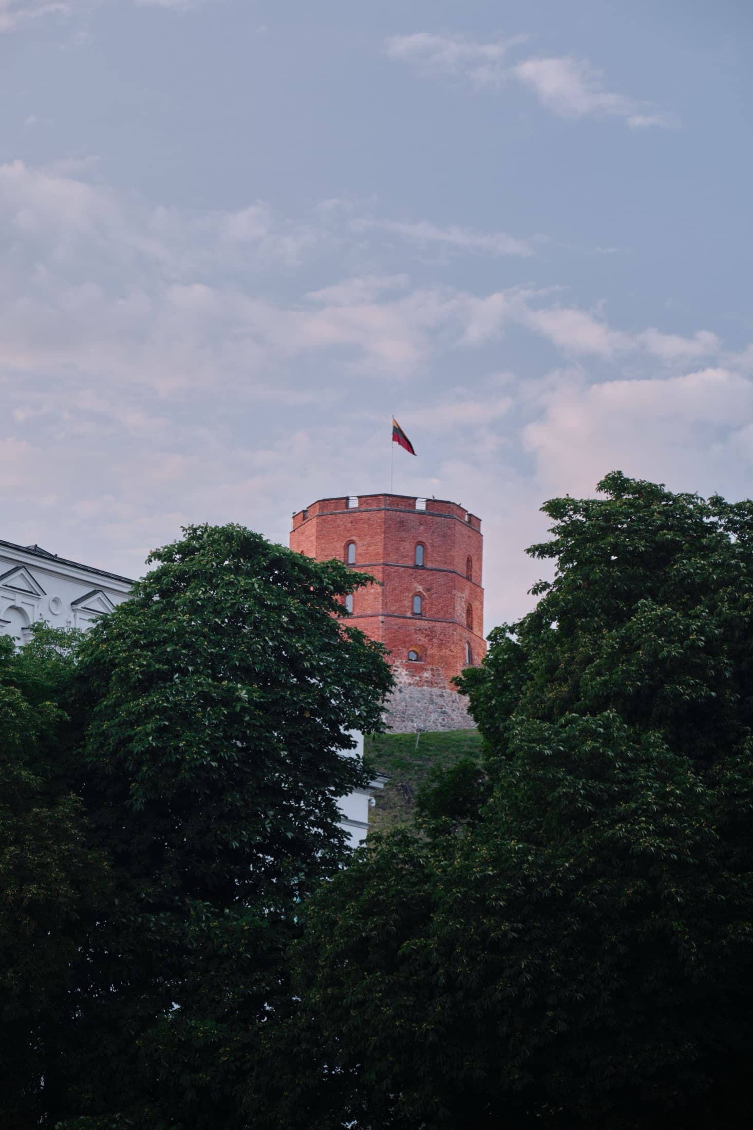 Gediminas Tower rising above lush greenery on Castle Hill in Vilnius