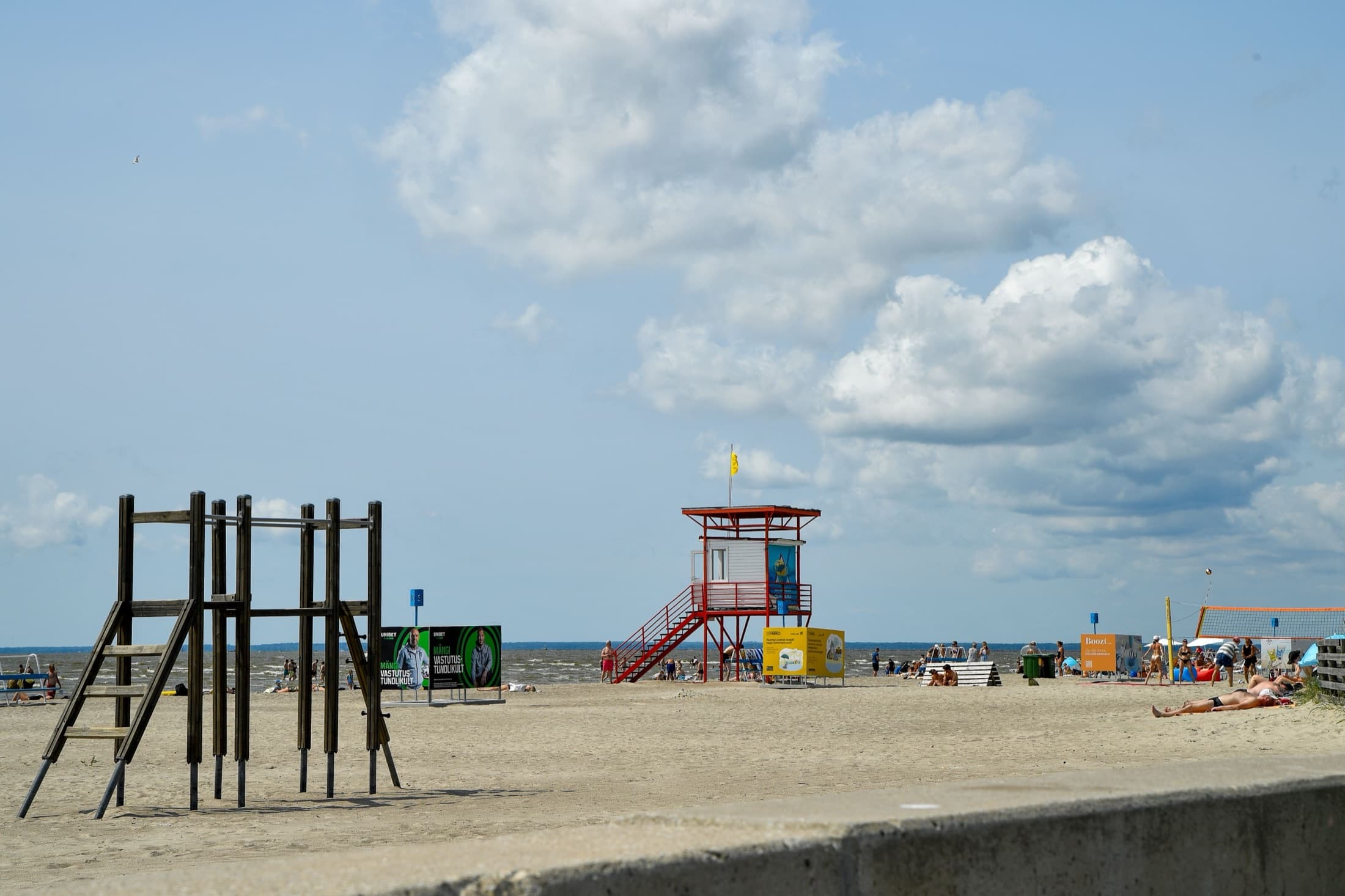 A sunny summer day at Parnu Beach with sandy shores and a lifeguard tower