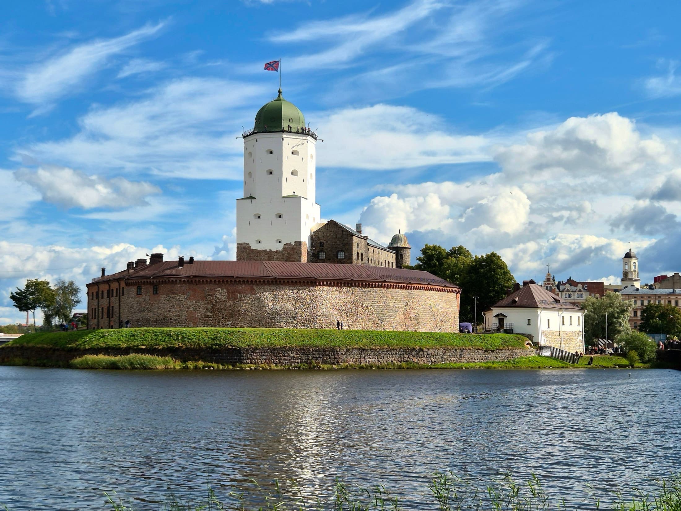 Vyborg Castle on a sunny day, surrounded by the river