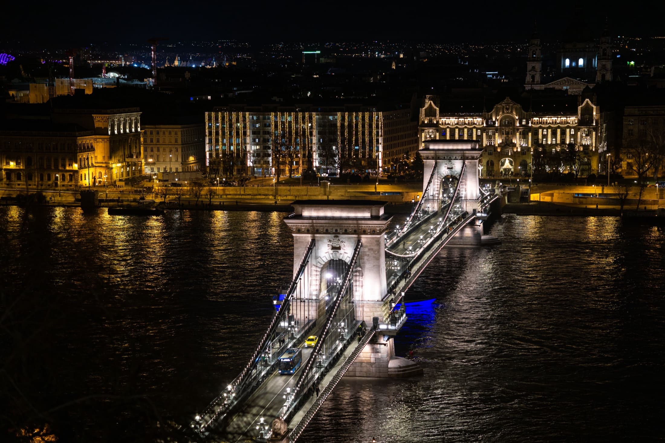 Aerial night view of the illuminated Szechenyi Chain Bridge over the Danube River