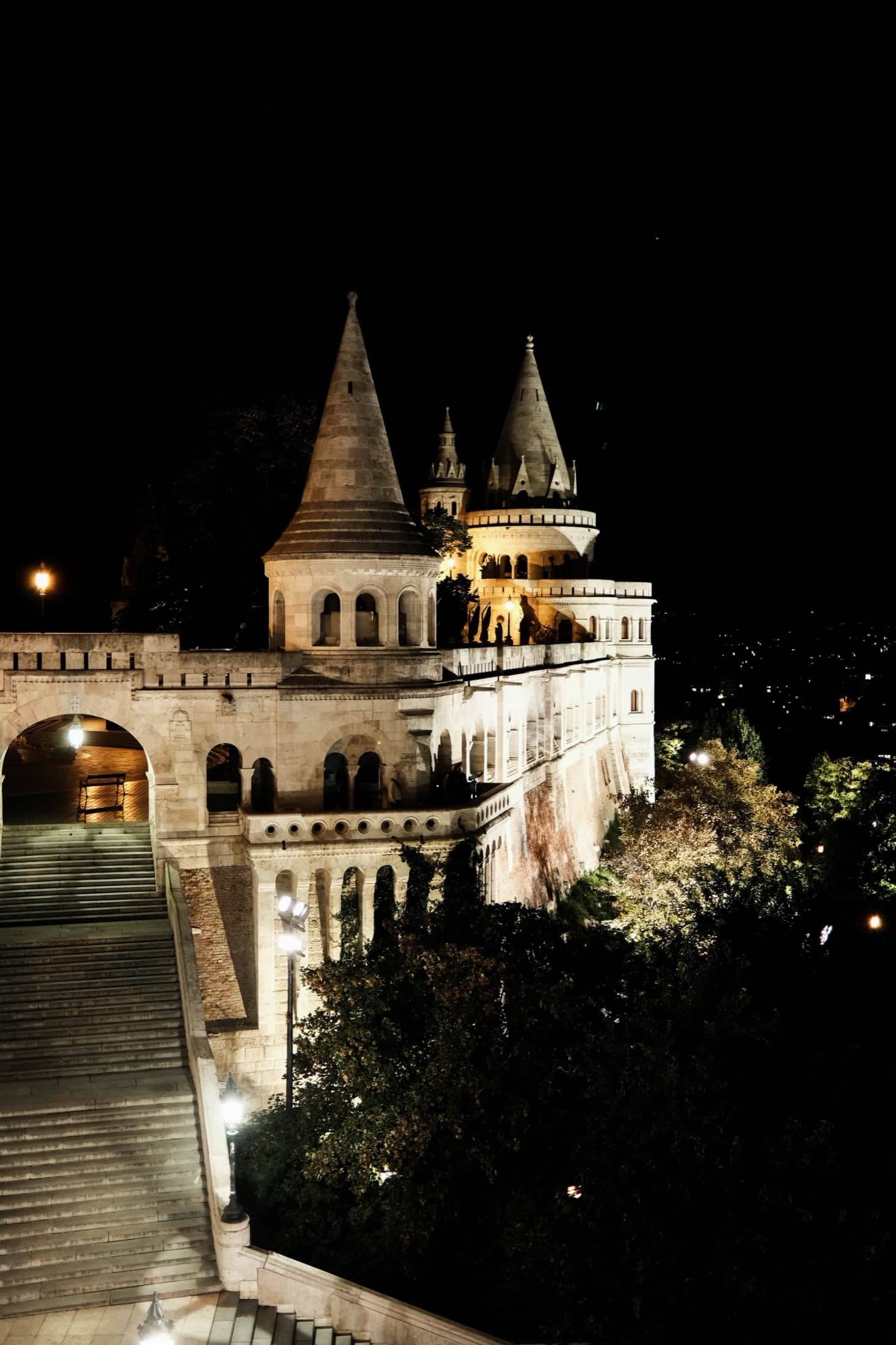 Fisherman's Bastion in Budapest lit up at night, showcasing its Gothic turrets