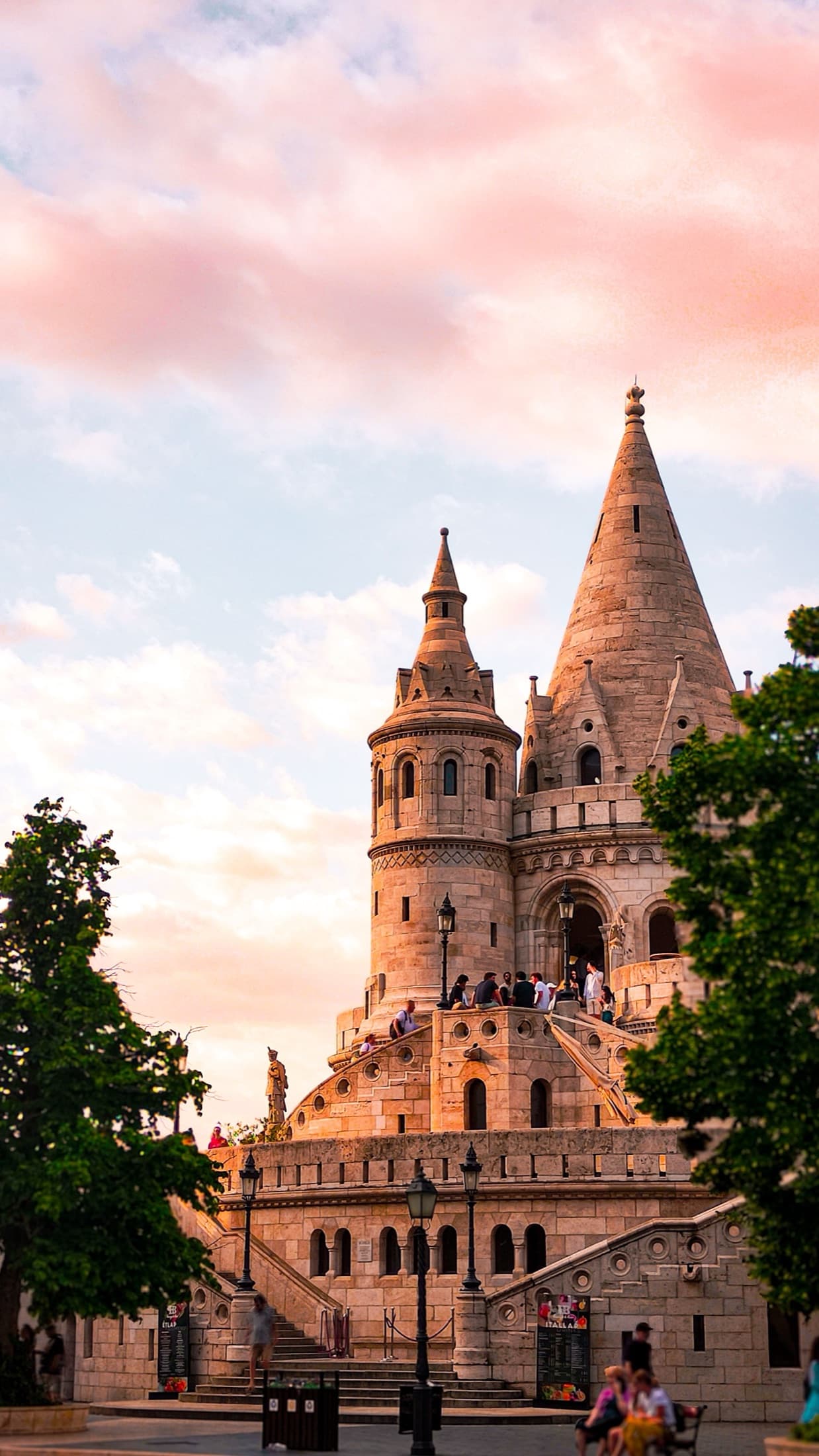 Gothic-style Fisherman's Bastion in Budapest with a colorful sunset backdrop