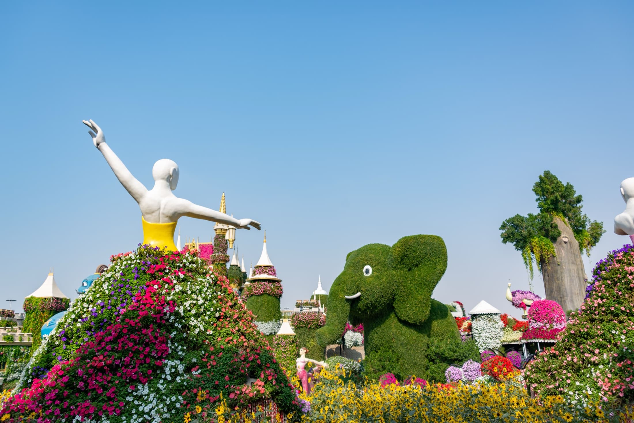 Vibrant floral sculptures and topiaries at Dubai Miracle Garden on a sunny day