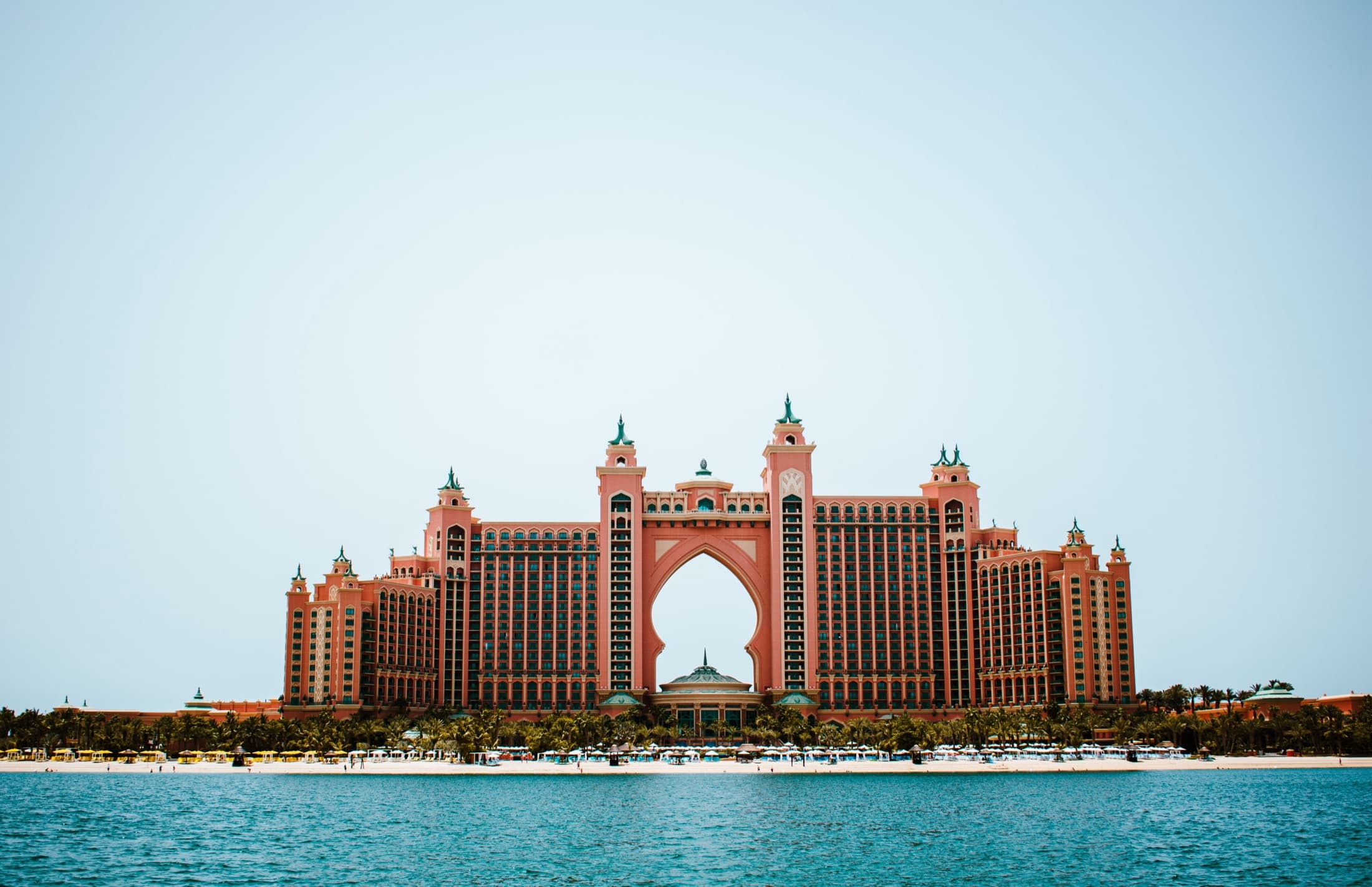 Atlantis The Palm resort on Palm Jumeirah under a clear blue sky with the ocean beyond