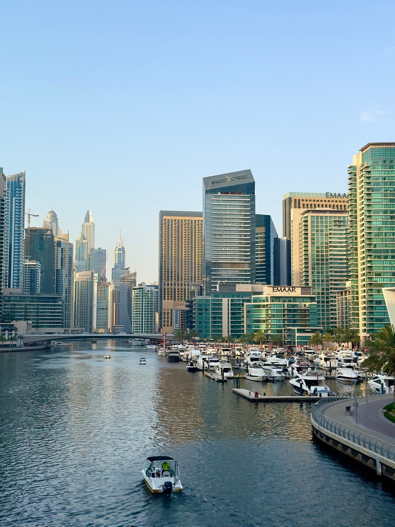 Dubai Marina's modern skyscrapers and luxury yachts on a sunny day