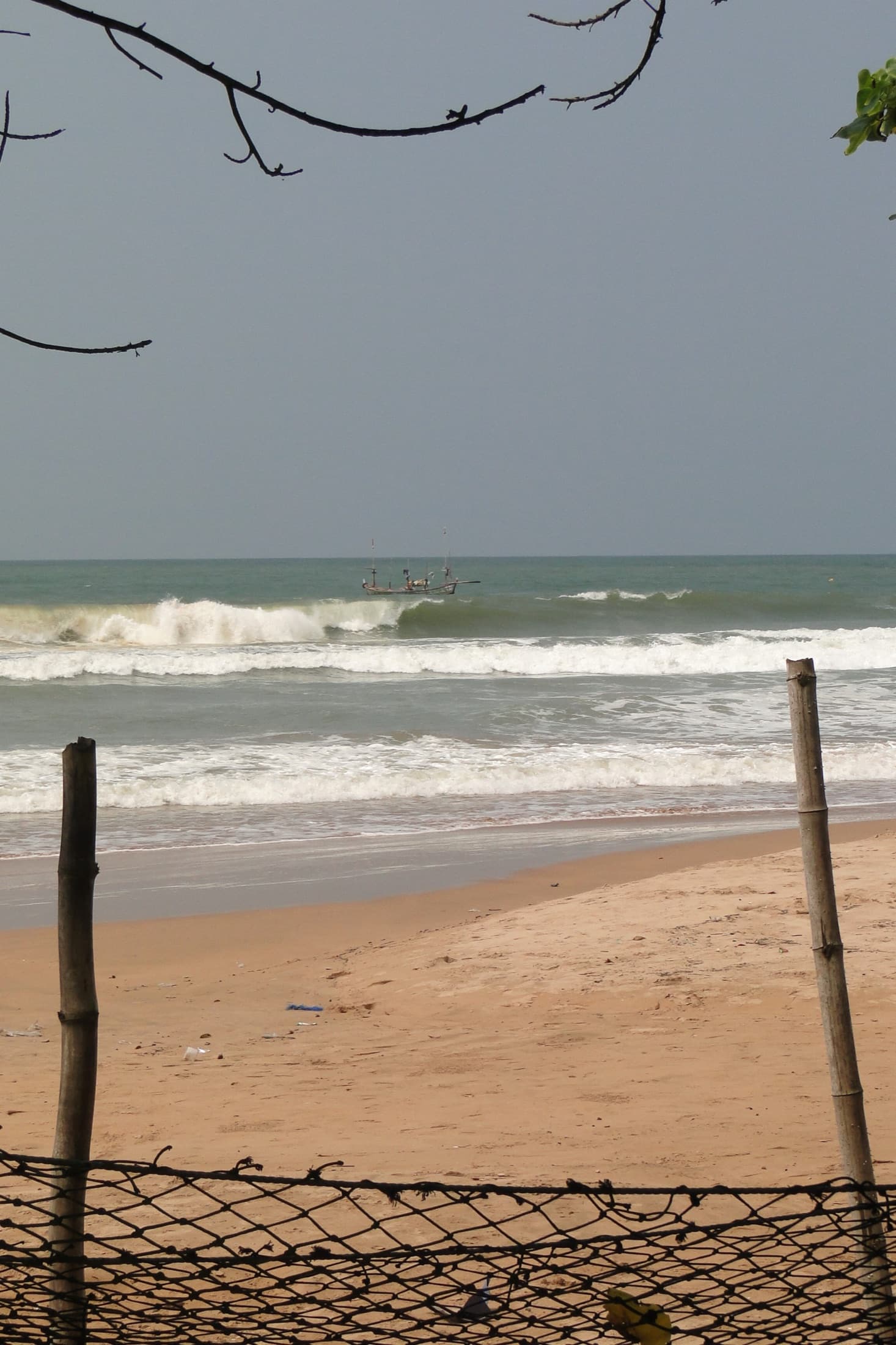 Waves rolling onto the sandy shore of Busua Beach in Ghana's Western Region