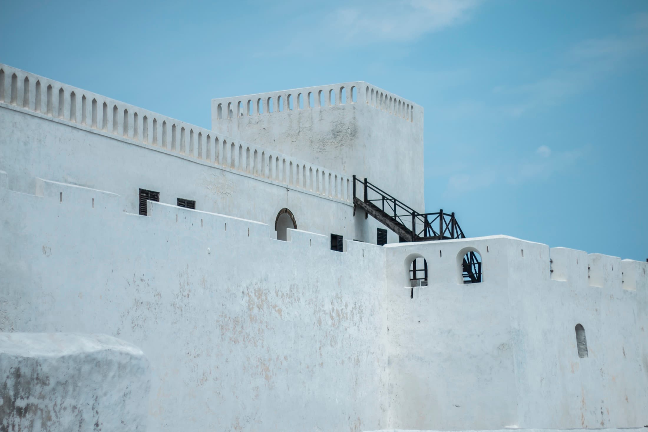 Elmina Castle's whitewashed walls rising above the Ghanaian coastline