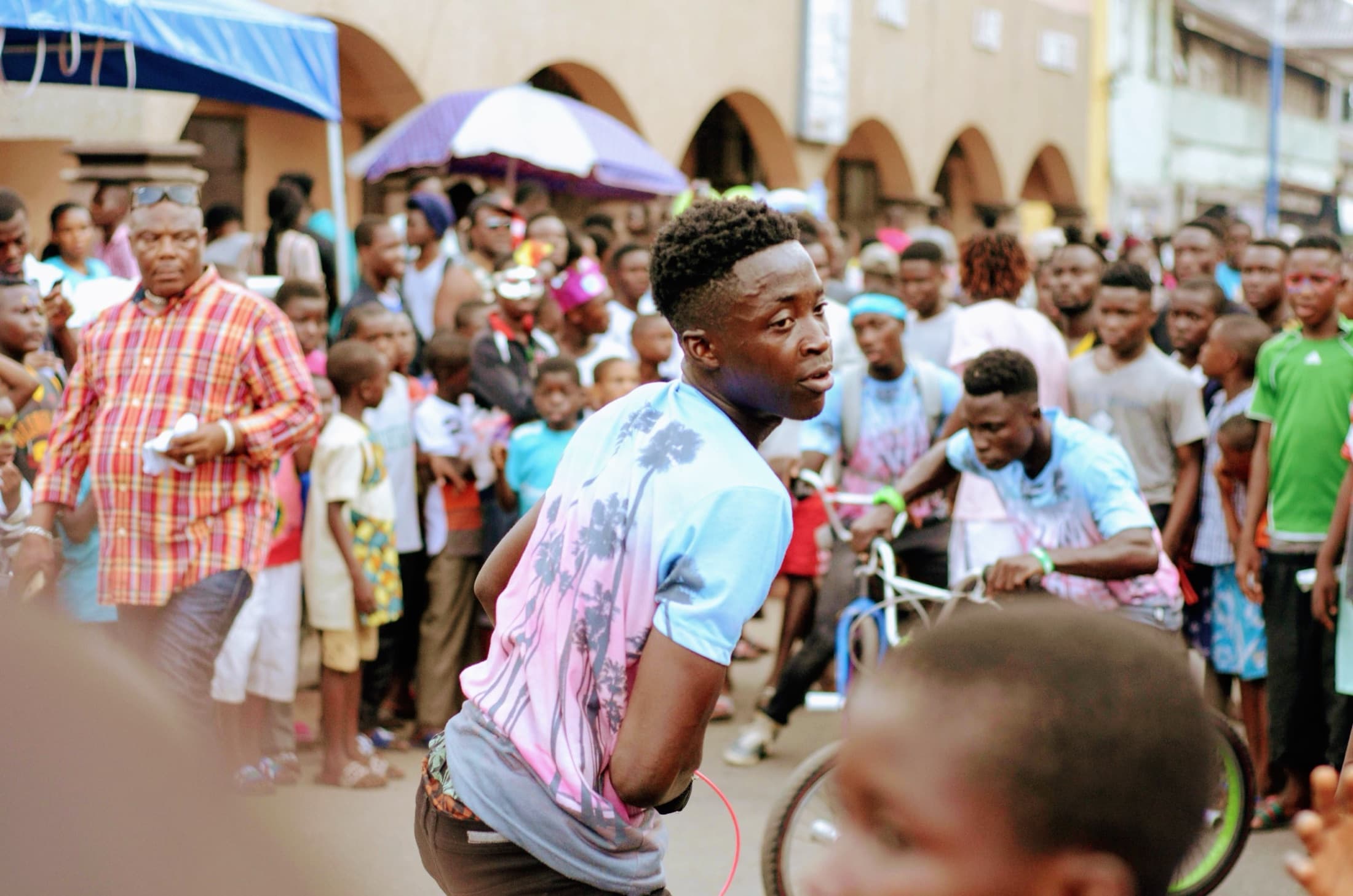 A bicycle stunt performance entertaining the crowd at the Chale Wote Street Art Festival