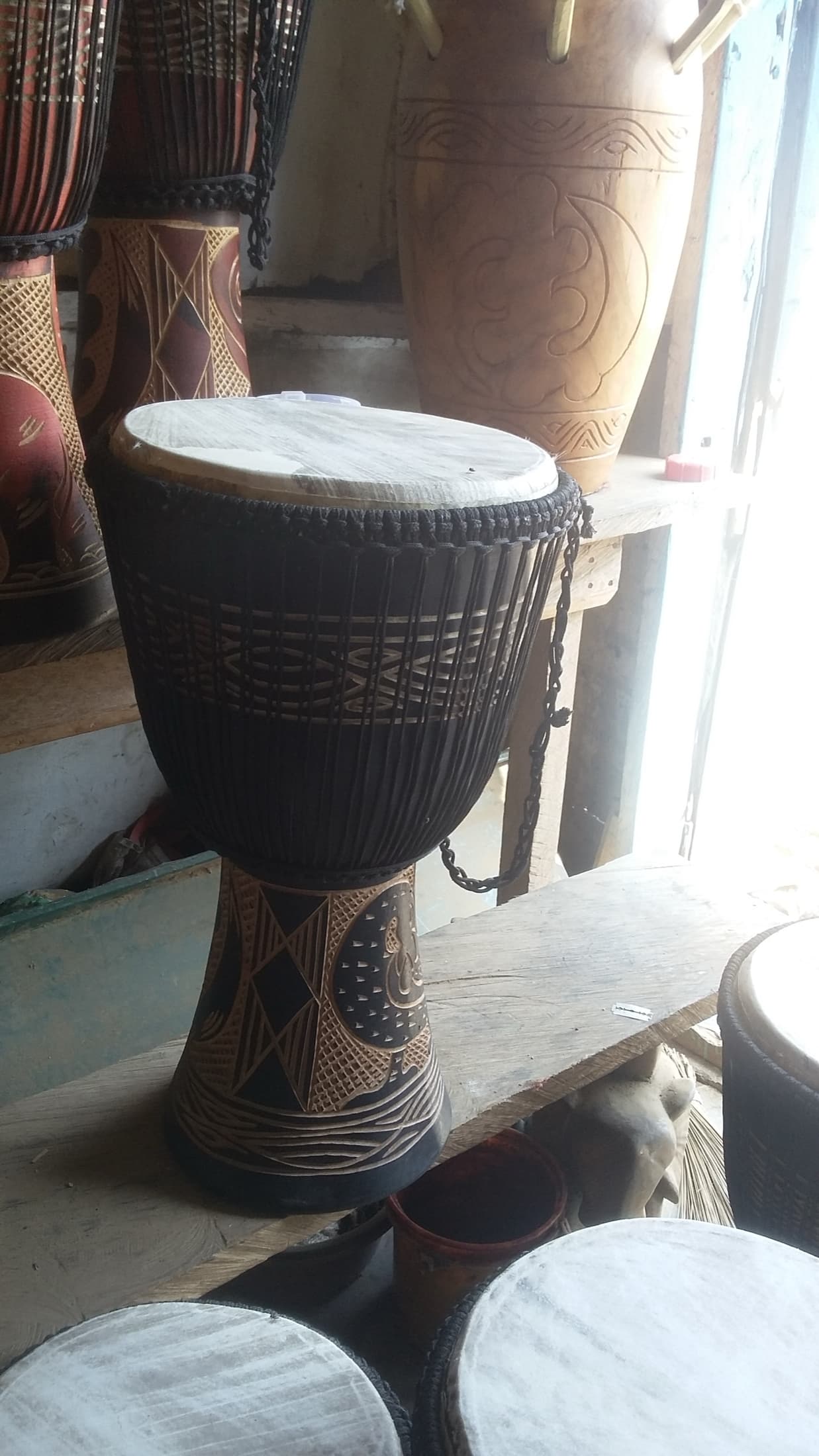 A hand-carved djembe drum, a traditional West African percussion instrument