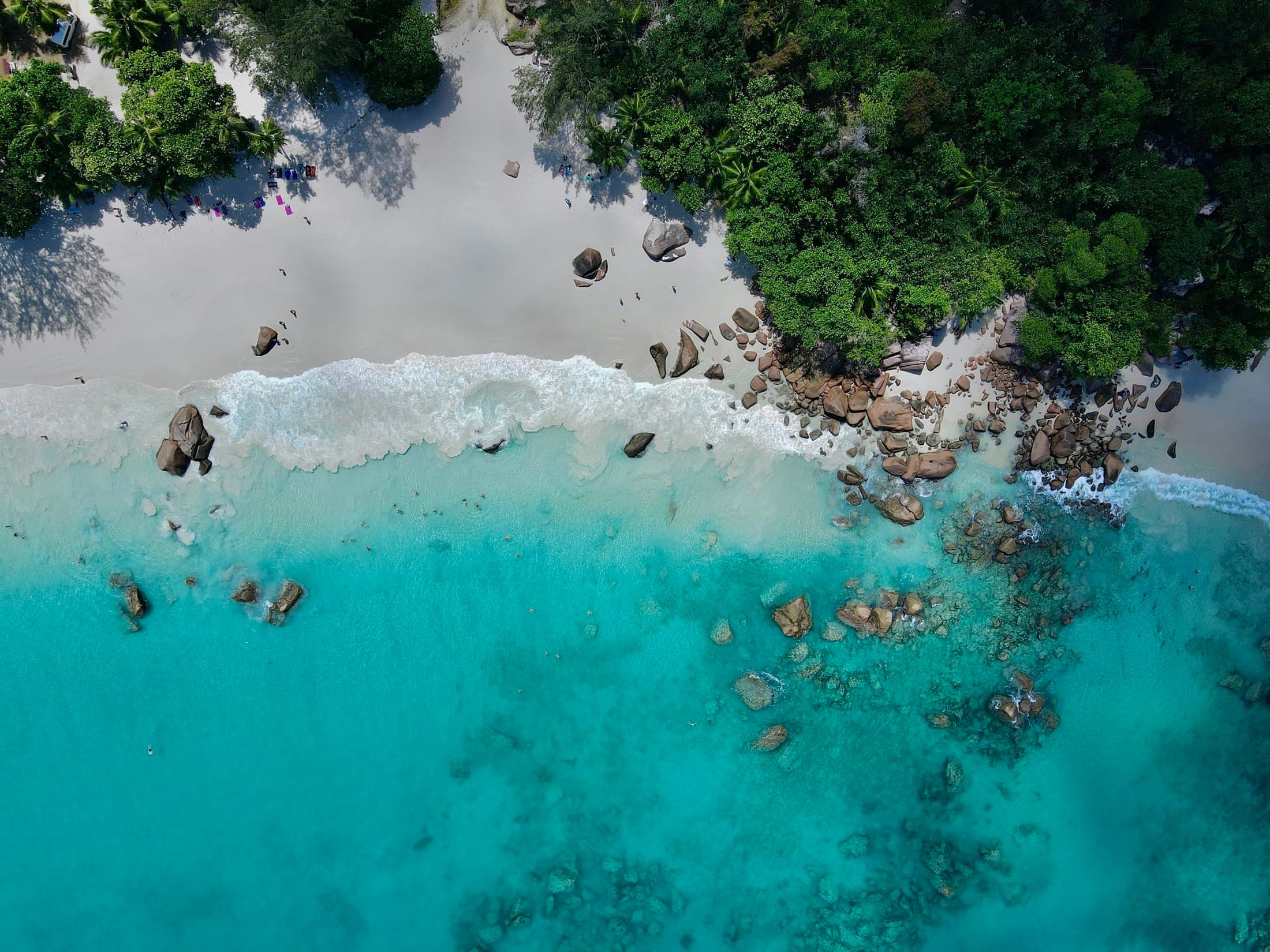 Aerial view of turquoise water along a Seychelles beach