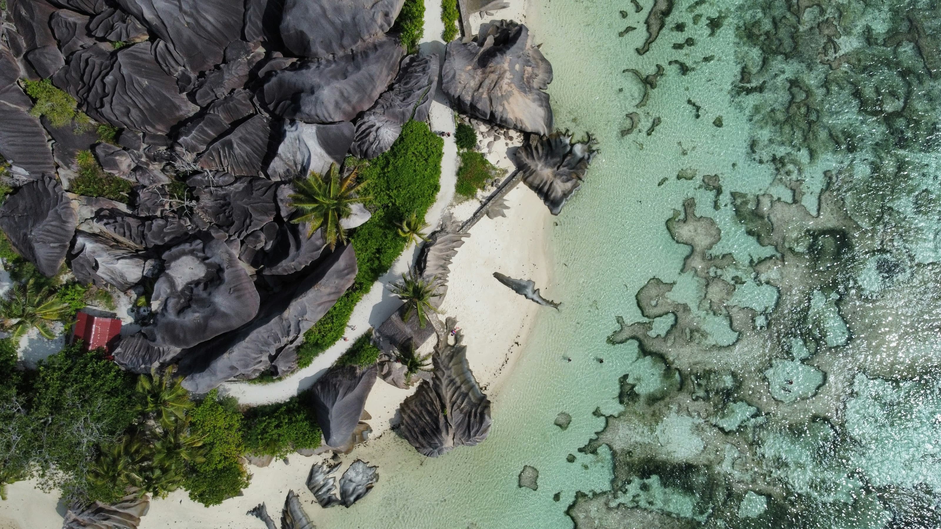 Aerial view of Anse Source d'Argent's granite boulders and turquoise water on La Digue, Seychelles