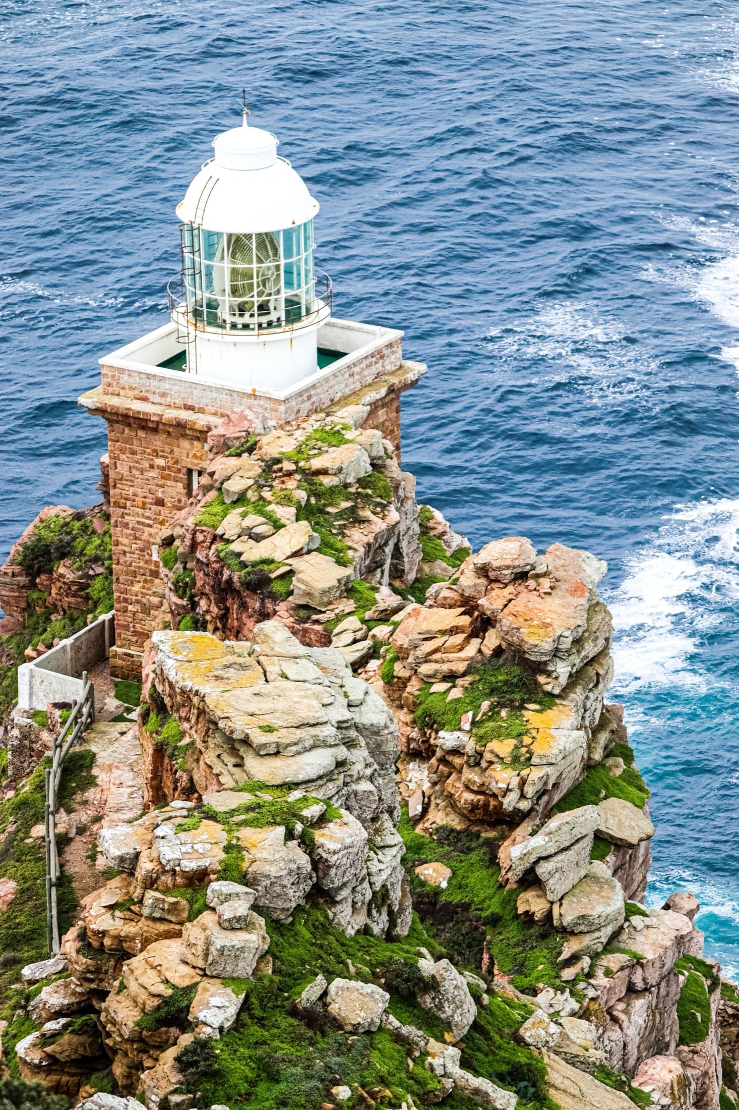 The Cape Point lighthouse perched on a rugged cliff overlooking the ocean, South Africa