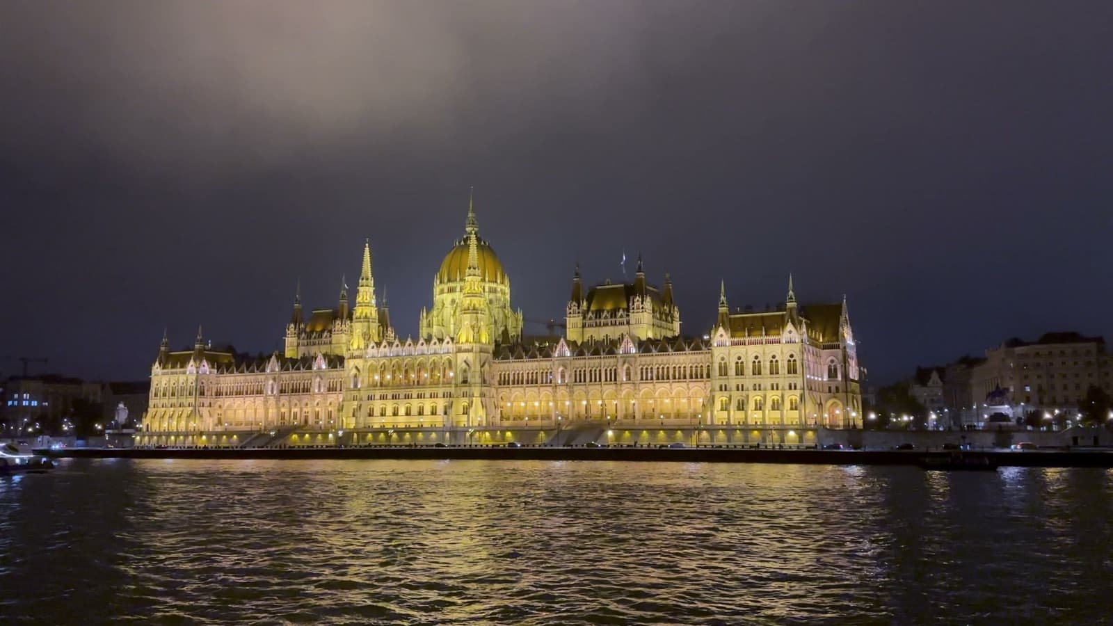 Ambient night view of the illuminated Hungarian Parliament Building reflecting on the Danube River