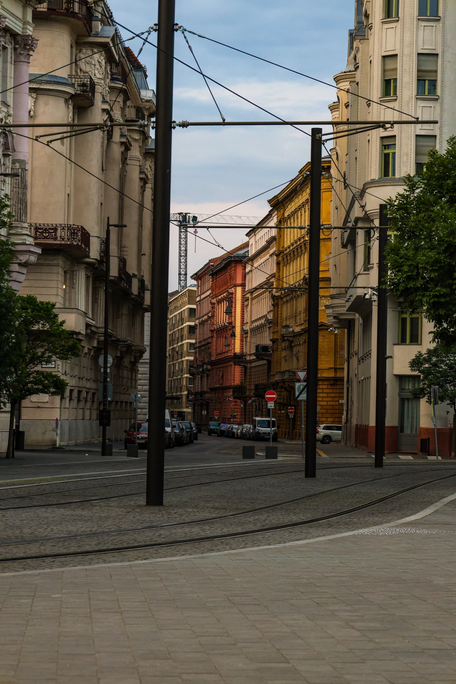 A narrow cobblestone street in Budapest with colorful historic architecture